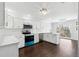 Bright, modern kitchen with white cabinetry, stainless steel appliances, and an island with sink at 8026 Rivermont Ct, Snellville, GA 30039