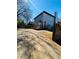 Backyard featuring a wood fence, driveway, and a home with a deck at 900 Ira Sw St, Atlanta, GA 30310