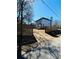 Backyard featuring a wood fence, driveway, and a home with a deck at 900 Ira Sw St, Atlanta, GA 30310