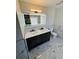 Bathroom featuring double sinks with vanity, tiled flooring, and a modern mirror at 900 Ira Sw St, Atlanta, GA 30310