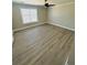 Bright bedroom featuring wood-look flooring, a ceiling fan, and a window for natural light at 900 Ira Sw St, Atlanta, GA 30310