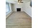 Spacious living room featuring a fireplace, a large window, and modern flooring at 900 Ira Sw St, Atlanta, GA 30310