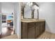 Bathroom featuring stylish granite countertops, double sinks, and trendy floral wallpaper at 1376 Stirling Nw Cir, Atlanta, GA 30318