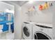 Convenient laundry area includes washer, dryer, and ample storage shelving at 1376 Stirling Nw Cir, Atlanta, GA 30318