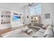 Open-concept living room with high ceilings, large windows, built-in shelving, and comfortable seating at 1376 Stirling Nw Cir, Atlanta, GA 30318