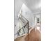 Bright staircase with wood steps and modern metal railing, bathed in natural light from large windows at 1376 Stirling Nw Cir, Atlanta, GA 30318