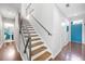 Modern staircase with metal railings, wood treads, and abundant natural light at 1376 Stirling Nw Cir, Atlanta, GA 30318