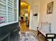 Inviting foyer with decorative rug, comfortable bench and a glimpse into the living room at 2016 Barberry Dr, Buford, GA 30519