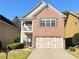 Charming brick home featuring a well-maintained lawn and a two-car garage at 2016 Barberry Dr, Buford, GA 30519