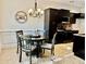 Cozy kitchen nook with a charming chandelier and modern dark cabinetry at 2016 Barberry Dr, Buford, GA 30519