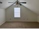 Bedroom with angled ceiling, ceiling fan, carpet, and a bright window at 3133 West Point Cir, Douglasville, GA 30134