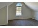 Cozy bedroom with angled ceiling, large window with view, and neutral carpet at 3133 West Point Cir, Douglasville, GA 30134