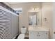 Bathroom featuring a modern vanity, toilet, and a striped shower curtain at 118 Savanna Estates Dr, Canton, GA 30115