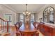 Formal dining room featuring a large table, chandelier, and ample natural light at 118 Savanna Estates Dr, Canton, GA 30115