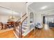 Bright foyer with hardwood floors, staircase, and an open view of the dining room and living room at 118 Savanna Estates Dr, Canton, GA 30115