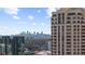 Picturesque skyline view showcasing modern high-rise buildings against a blue sky with fluffy clouds at 3475 Oak Valley Ne Rd # 410, Atlanta, GA 30326