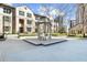 Charming building exterior featuring a beautiful courtyard with a gazebo and manicured landscaping at 3475 Oak Valley Ne Rd # 410, Atlanta, GA 30326