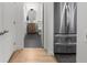 Hallway showcasing a stainless steel refrigerator and entrance into a bathroom with modern decor at 3475 Oak Valley Ne Rd # 410, Atlanta, GA 30326