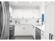 Modern kitchen with white cabinets, stainless steel appliances, and sleek countertops at 3475 Oak Valley Ne Rd # 410, Atlanta, GA 30326
