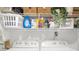 Bright laundry area offers ample shelving above a modern, front-load washer and dryer set at 3475 Oak Valley Ne Rd # 410, Atlanta, GA 30326