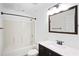 Bathroom featuring a shower and tub, vanity and a framed mirror at 4046 Harvest Ridge Dr, Douglasville, GA 30135