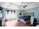 Bedroom with a black bed set, light blue walls and a ceiling fan at 4046 Harvest Ridge Dr, Douglasville, GA 30135