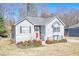 Charming two-story home with gray siding, dark shutters, a red front door, and neatly manicured landscaping at 4046 Harvest Ridge Dr, Douglasville, GA 30135
