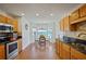 Open kitchen with stainless steel appliances, granite countertops, and a sunny breakfast nook at 4046 Harvest Ridge Dr, Douglasville, GA 30135