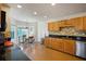 Well-lit kitchen featuring wood cabinets, granite countertops, and a breakfast nook with natural light at 4046 Harvest Ridge Dr, Douglasville, GA 30135