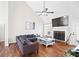 Bright living room with a vaulted ceiling, fireplace, and hardwood floors, creating a warm, inviting atmosphere at 4046 Harvest Ridge Dr, Douglasville, GA 30135