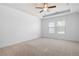 Spacious bedroom with tray ceiling and large windows providing natural light at 505 Windy Ridge Ct, Canton, GA 30114
