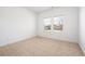 Bright bedroom featuring neutral carpet, white walls, baseboards, and double window at 505 Windy Ridge Ct, Canton, GA 30114