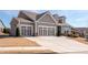 Charming home with a three-car garage and manicured lawn, showcasing excellent curb appeal at 505 Windy Ridge Ct, Canton, GA 30114