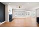 Open-concept living room featuring a fireplace, wood flooring, and large windows for natural light at 505 Windy Ridge Ct, Canton, GA 30114