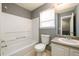 Cozy bathroom featuring a bath and shower, toilet, and sink with vanity at 215 Odyssey Turn, Conyers, GA 30012