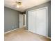 Bedroom has double closet, ceiling fan and neutral carpet at 215 Odyssey Turn, Conyers, GA 30012