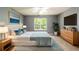 Well-lit bedroom featuring a large window, ceiling fan, and plush carpet at 215 Odyssey Turn, Conyers, GA 30012