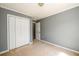 This is a cozy bedroom with carpet floors, a large closet, and neutral paint at 215 Odyssey Turn, Conyers, GA 30012