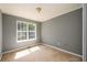 Empty bedroom with gray walls, plush carpet, and a large window at 215 Odyssey Turn, Conyers, GA 30012