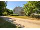 Spacious two-story home with large front yard and lush trees providing shade at 215 Odyssey Turn, Conyers, GA 30012