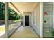 Covered front porch with railing and neutral siding, offering a welcoming entryway at 215 Odyssey Turn, Conyers, GA 30012
