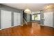 Open-concept living space with hardwood floors, staircase, and plenty of natural light at 215 Odyssey Turn, Conyers, GA 30012