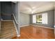 Living room with hardwood floors, large window and ceiling fan at 215 Odyssey Turn, Conyers, GA 30012