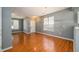Open living area with hardwood floors, large windows, and an elegant chandelier fixture at 215 Odyssey Turn, Conyers, GA 30012