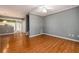 Open living area with hardwood floors leads to the kitchen and staircase at 215 Odyssey Turn, Conyers, GA 30012