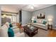 Bright living room features neutral walls, ceiling fan, and hardwood floors at 215 Odyssey Turn, Conyers, GA 30012