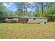 Expansive backyard featuring a well-maintained lawn, trees, and a single-story home with white brick at 3363 Briarcliff Ne Rd, Atlanta, GA 30345