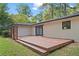 Large wooden deck in a backyard with access to the home and a newly painted white brick exterior at 3363 Briarcliff Ne Rd, Atlanta, GA 30345