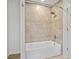 Bathroom with neutral tile, a bathtub, and a shower featuring mosaic accents at 3363 Briarcliff Ne Rd, Atlanta, GA 30345
