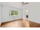 Bright bedroom with hardwood floors and a ceiling fan, adjacent to an ensuite bathroom at 3363 Briarcliff Ne Rd, Atlanta, GA 30345